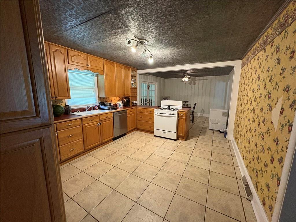 15 John Ross Drive Southwest Rome, GA 30165 - Photo 6 of 10 a kitchen with stainless steel appliances a refrigerator sink and microwave