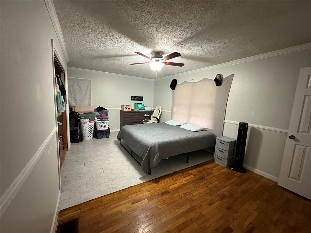 15 John Ross Drive Southwest Rome, GA 30165 - Photo 7 of 10 a bedroom with a bed and a chandelier