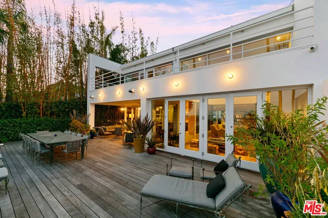 a bedroom with a large bed and a large window