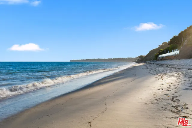 a bedroom with furniture and a large window