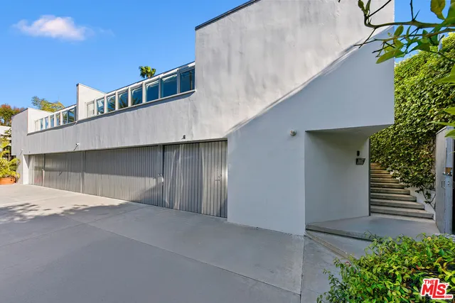 a living room with furniture and floor to ceiling window