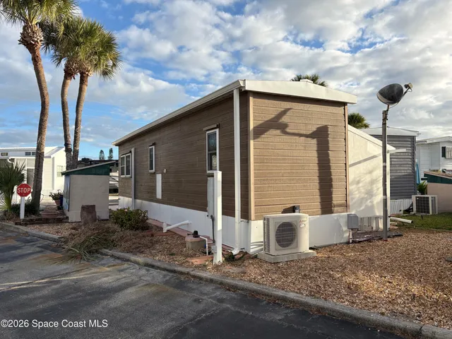 a bedroom with a bed and painting on the wall