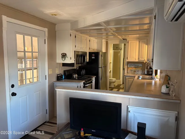 a view of swimming pool with lounge chair and dinning table under an umbrella