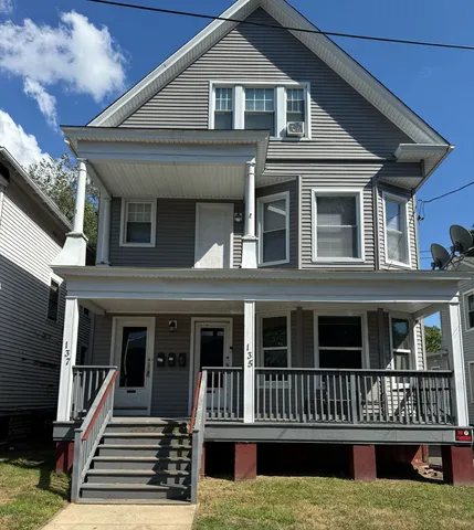 a front view of a house with garden and porch