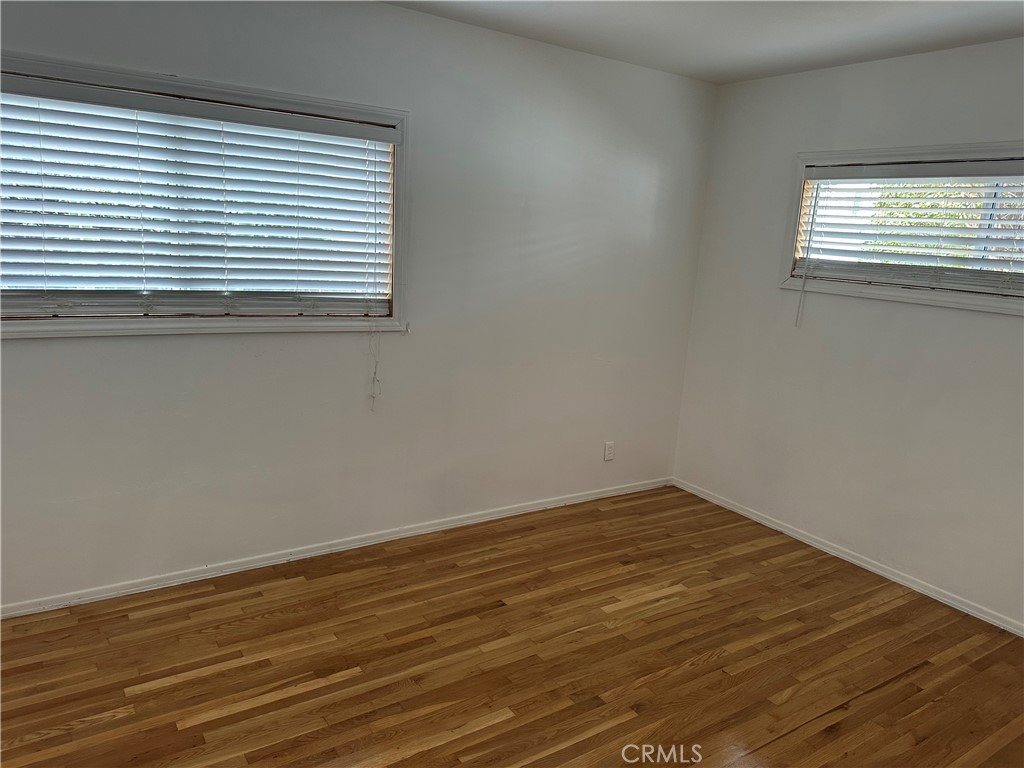 803 1/2 East Newmark Avenue Monterey Park, CA 91755 - Photo 5 of 9 a view of a room that has wooden floor and a window