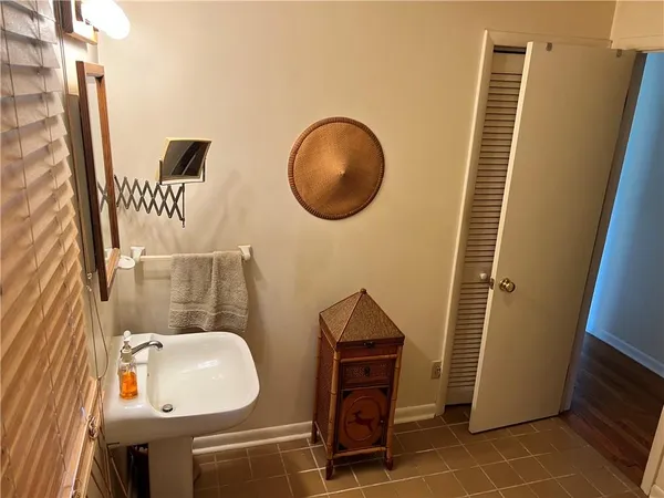 a bathroom with a sink a toilet and mirror