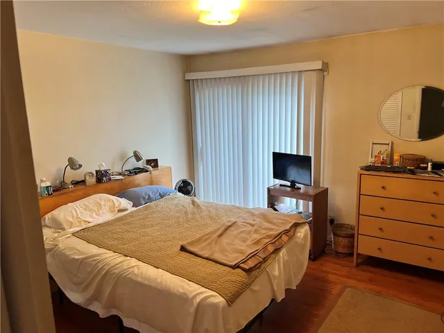 a bedroom with a bed and flat screen tv