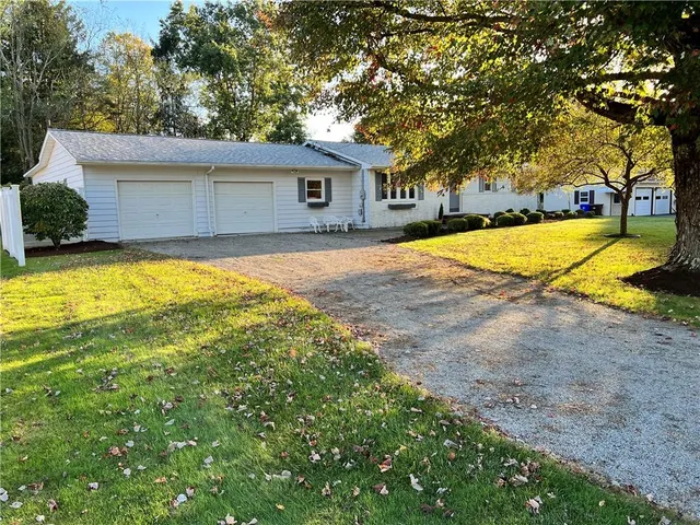 a view of a house with pool and sitting area