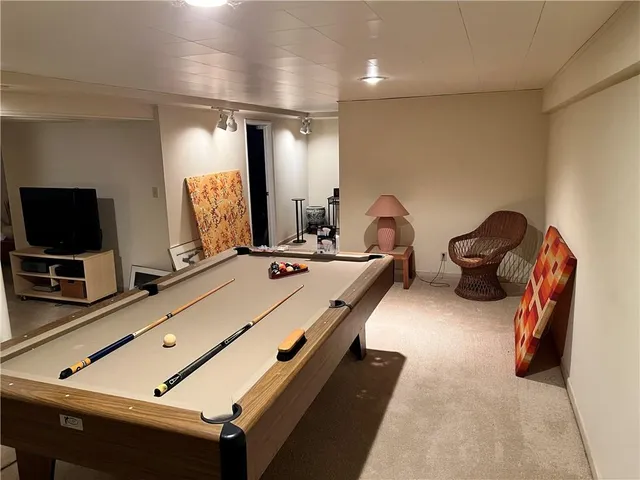 a room with gym equipment and a flat screen tv