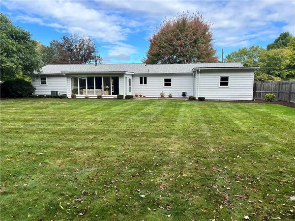 a view of a house with a backyard