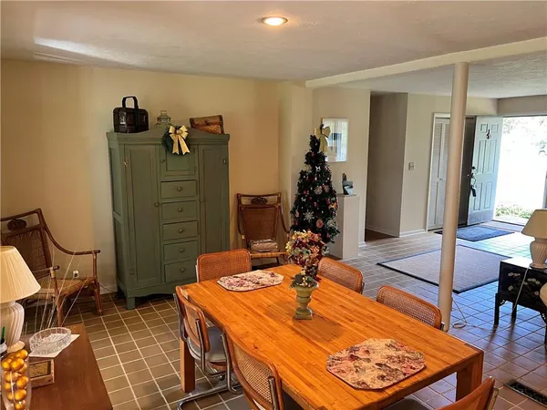 a dining room with furniture and a rug