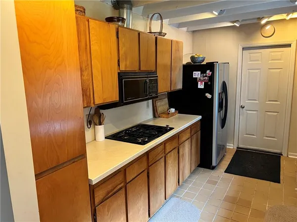 a kitchen with stainless steel appliances a refrigerator and a stove