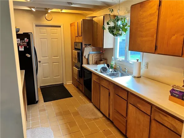 a kitchen with stainless steel appliances a sink and a refrigerator
