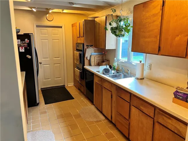 a kitchen with stainless steel appliances a sink and a refrigerator