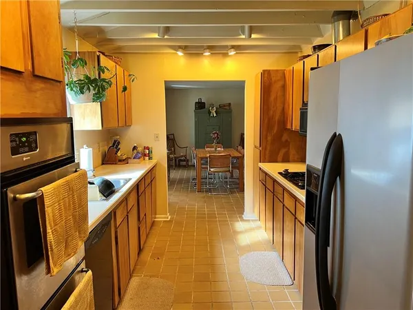 a view of a hallway with dining area and chandelier