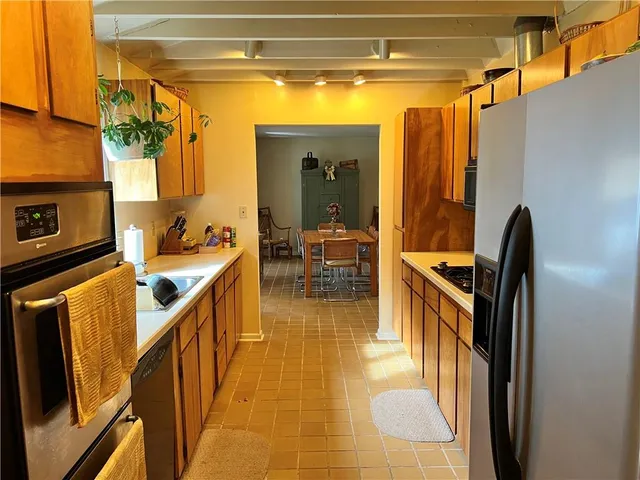 a view of a hallway with dining area and chandelier