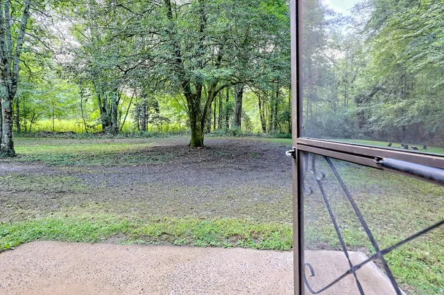 a kitchen with a sink a stove cabinets and a wooden floor