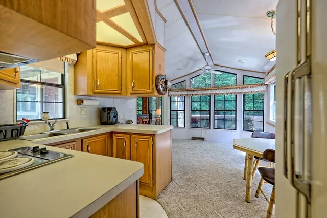 a kitchen with stainless steel appliances granite countertop a refrigerator a stove top oven a sink and dishwasher