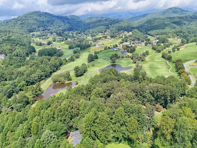 an aerial view of a house with a yard basket ball court and outdoor seating