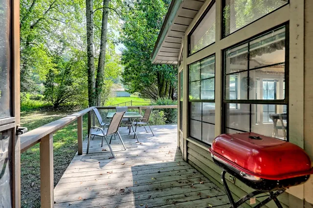 a very nice looking dining room with a large window and chandelier