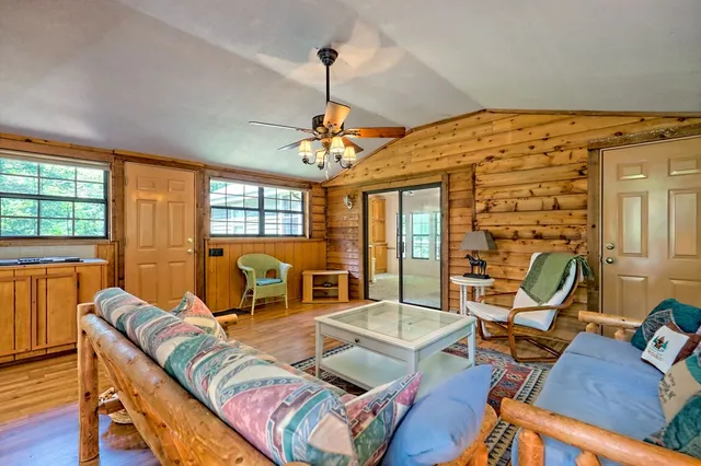 a bedroom with a bed and a large window with outer view