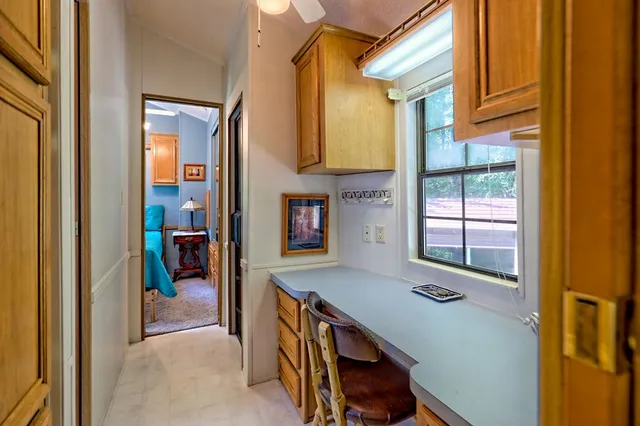 a front view of a house with a garden and trees