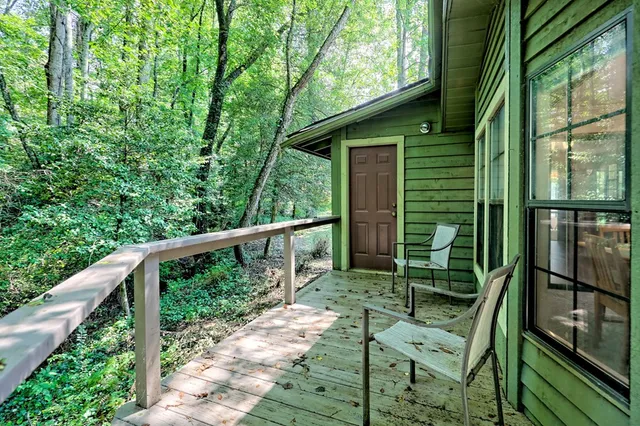 an aerial view of residential house with outdoor space and trees all around