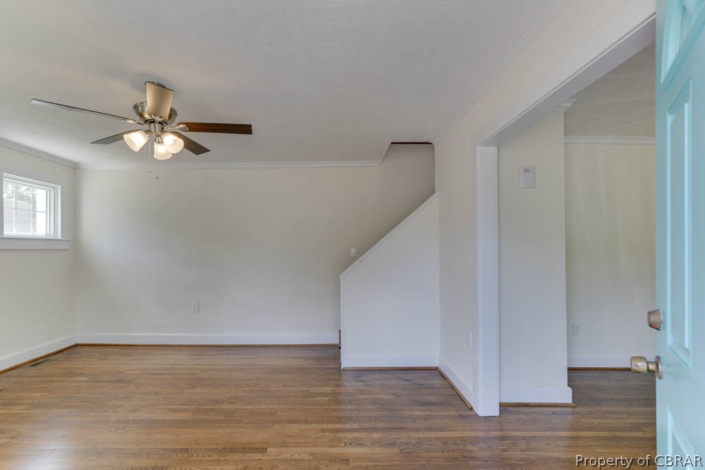 Additional living space featuring ceiling fan and wood-type flooring