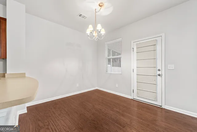 a view of a room with wooden floor and cabinet