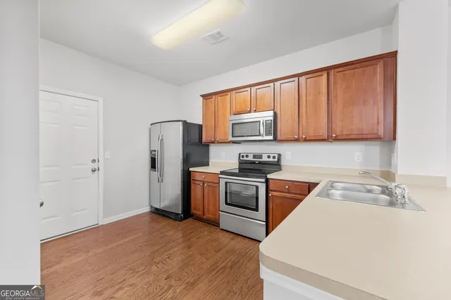 a kitchen with a refrigerator stove and sink