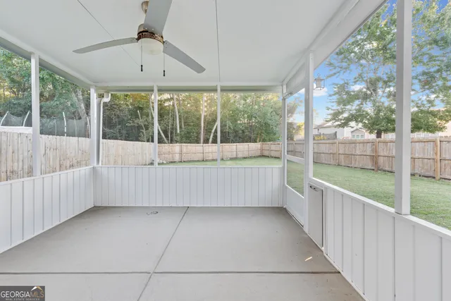 a view of outdoor space with wooden floor and windows