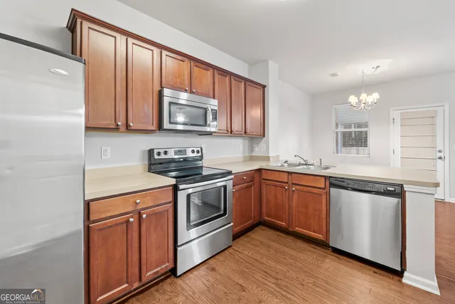 a kitchen with sink a microwave and cabinets