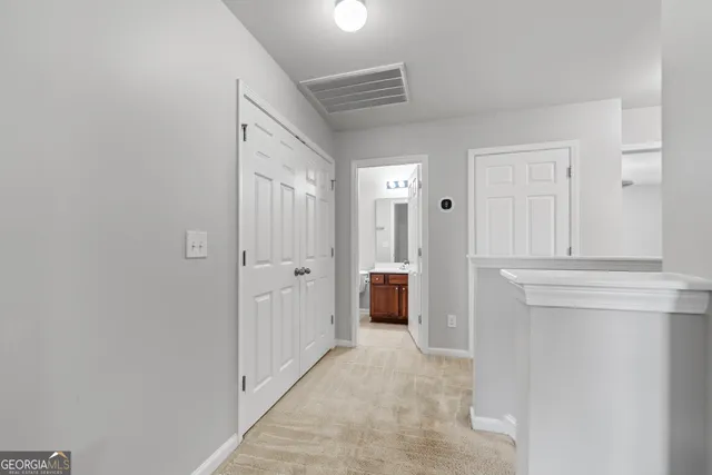 a view of a hallway with dining area