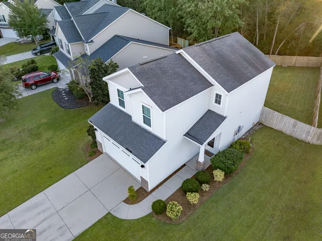 an aerial view of a house with garden space and street view