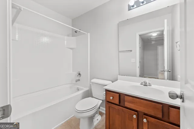 a bathroom with a sink toilet a mirror and shower