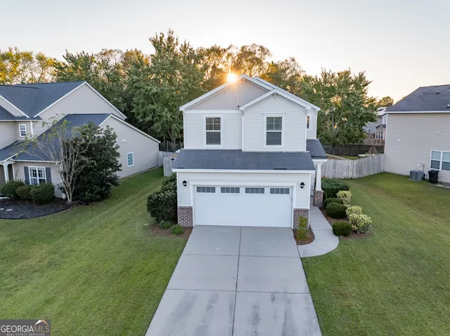 a view of a house with garden and yard