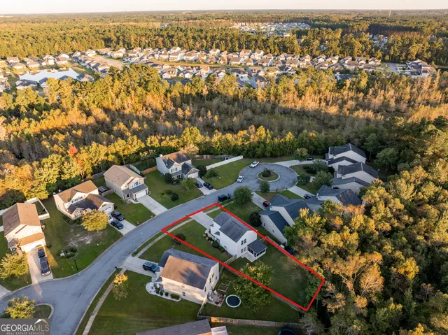 an aerial view of residential houses with outdoor space