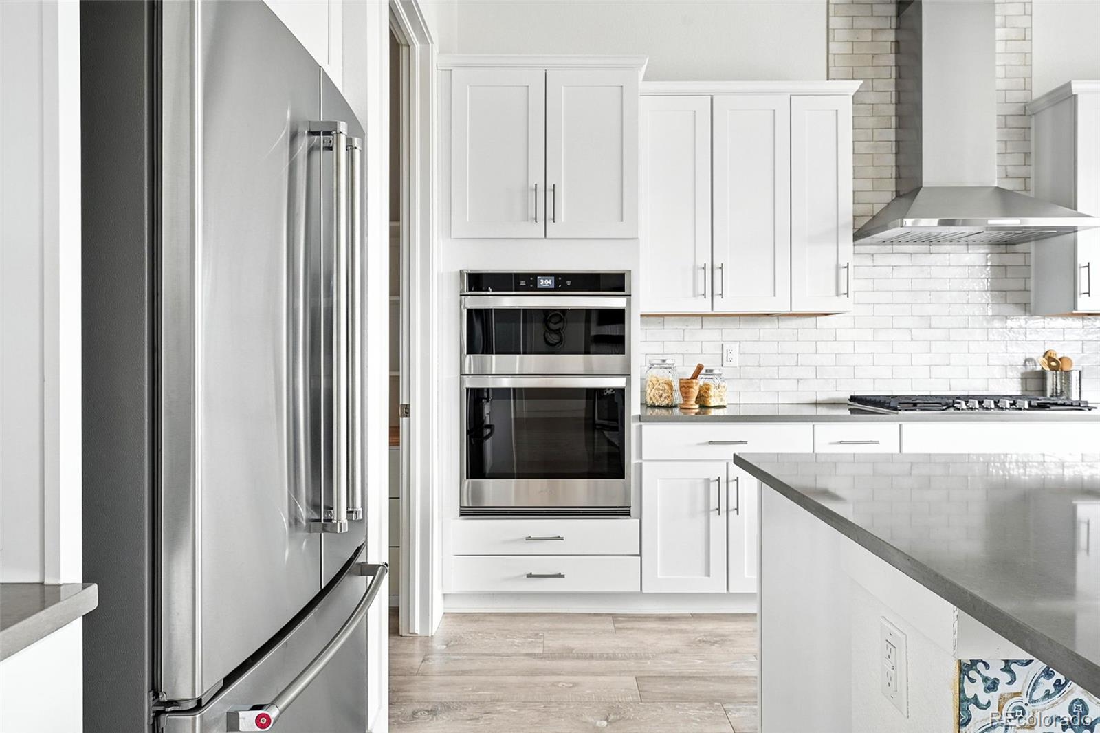 4855 Saddle Iron Road Castle Rock, CO 80104 - Photo 12 of 50 a kitchen with stainless steel appliances granite countertop a stove and a refrigerator