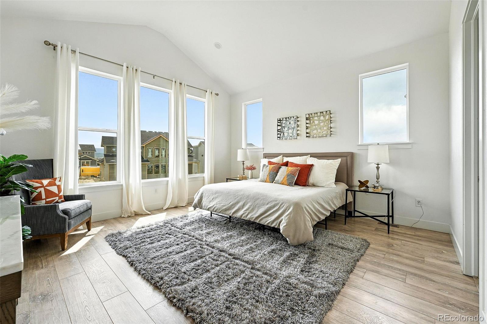 4855 Saddle Iron Road Castle Rock, CO 80104 - Photo 25 of 50 a spacious bedroom with a large bed and a couch