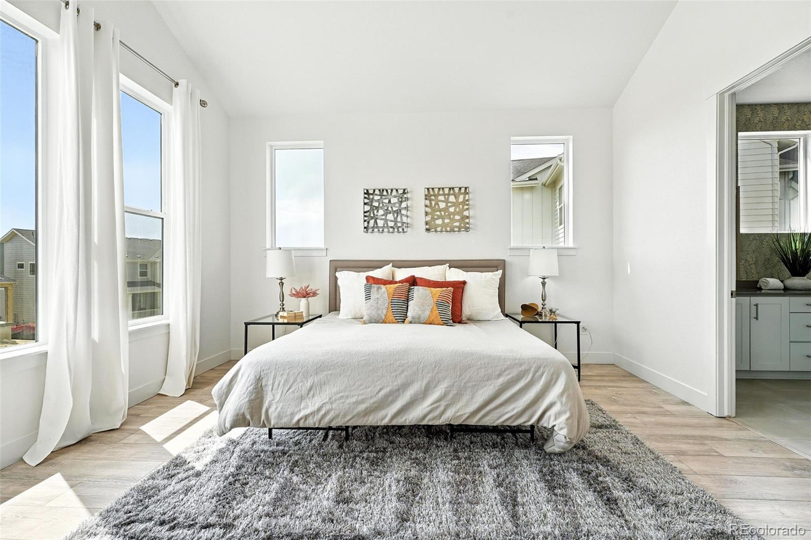 4855 Saddle Iron Road Castle Rock, CO 80104 - Photo 26 of 50 a bedroom with a large bed and a window