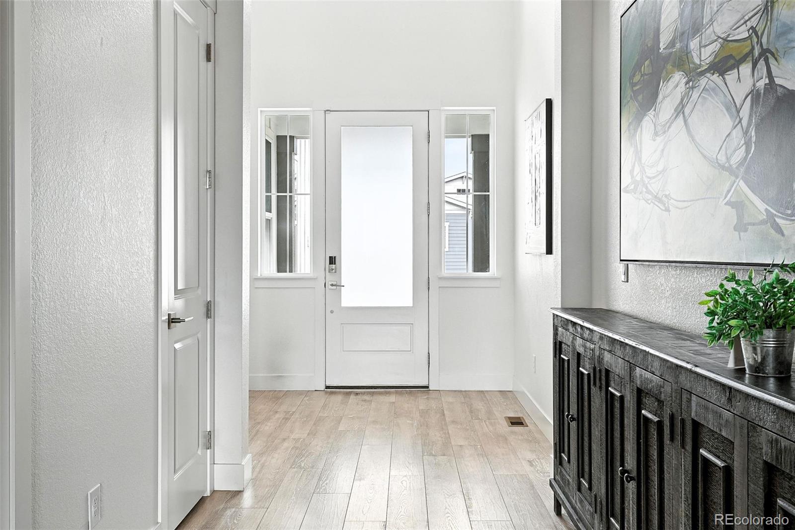 4855 Saddle Iron Road Castle Rock, CO 80104 - Photo 5 of 50 a view of a hallway with wooden floor and entryway