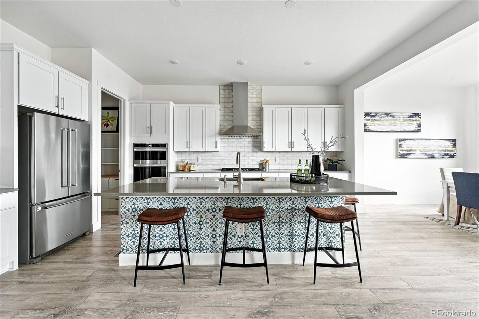 4855 Saddle Iron Road Castle Rock, CO 80104 - Photo 8 of 50 a kitchen with stainless steel appliances granite countertop a refrigerator and a stove top oven