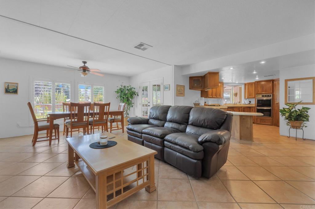 1010 Palm Canyon Drive, Unit 249 Borrego Springs, CA 92004 - Photo 4 of 23 a living room with furniture and a dining table with kitchen view