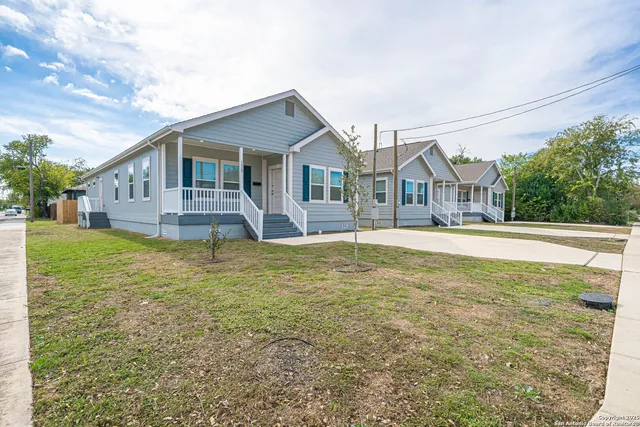 a front view of a house with a yard and lake view