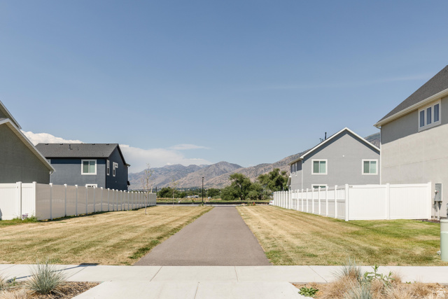 349 West 3085 South Logan, UT 84321 - Photo 36 of 37 Paved walking path bordered by expansive green space and white privacy fencing