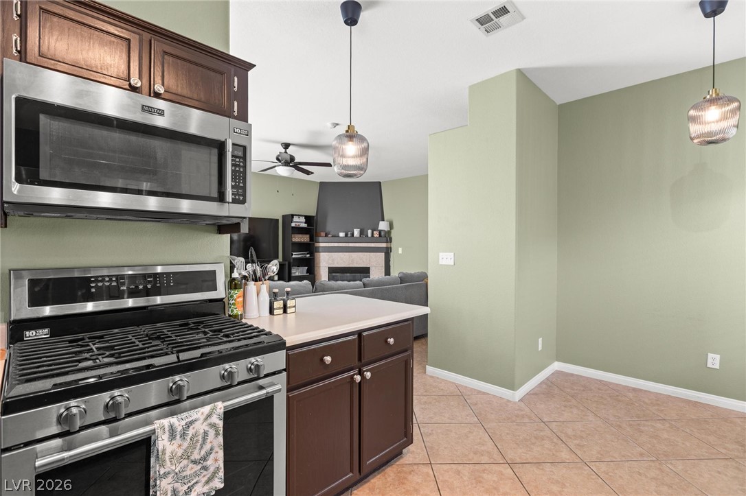 3238 Mystic Ridge Court Las Vegas, NV 89129 - Photo 7 of 31 A well-appointed kitchen featuring a stainless steel gas range and ample counter space.