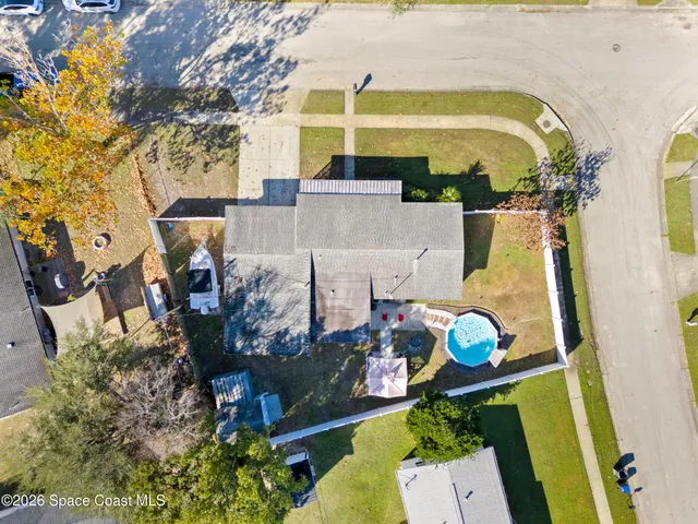 an aerial view of a house with a table and chairs