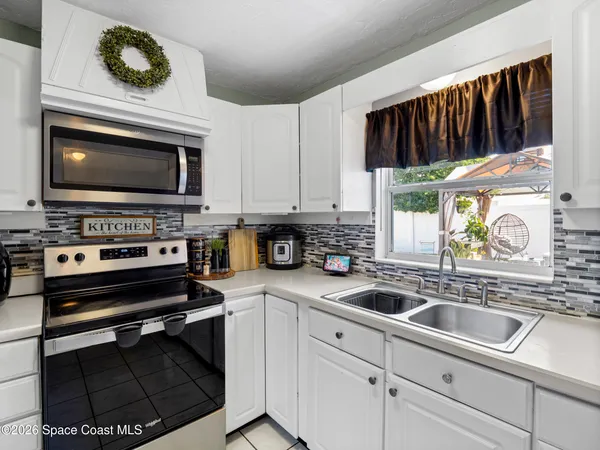 a kitchen with stainless steel appliances a stove a sink and a microwave