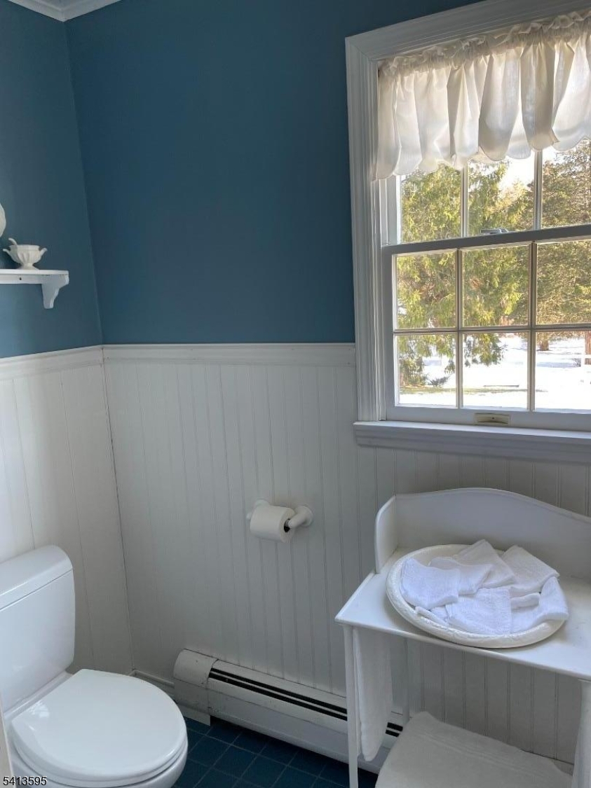 938 Potters Road Newton, NJ 07860 - Photo 14 of 26 a bathroom with a toilet sink and window