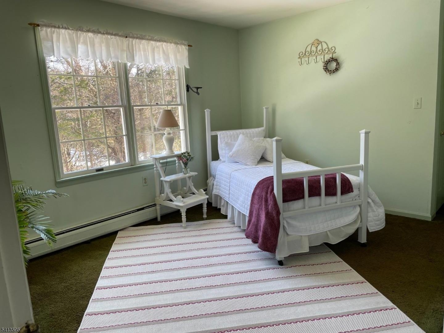 938 Potters Road Newton, NJ 07860 - Photo 18 of 26 a bed sitting in a bedroom next to a window